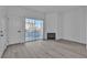 Living room features a fireplace, modern flooring, and sliding door to a balcony at 3318 N Decatur Blvd # 1035, Las Vegas, NV 89130