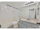 Bright bathroom features a shower-tub combo, a white sink vanity, and neutral tile flooring at 3514 Jordan Ln, North Las Vegas, NV 89032