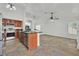 Open-concept kitchen with stainless steel appliances, cherry wood cabinets, and tile flooring at 3514 Jordan Ln, North Las Vegas, NV 89032