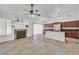 Open-concept kitchen with stainless steel appliances, cherry wood cabinets, and a large island at 3514 Jordan Ln, North Las Vegas, NV 89032