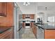 Kitchen featuring stainless steel appliances, tile floors, and cherry wood cabinets at 3514 Jordan Ln, North Las Vegas, NV 89032