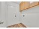 Laundry room with overhead cabinets, utility connections, and a bright white door perfect for chores at 3514 Jordan Ln, North Las Vegas, NV 89032