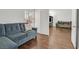 Bright living room featuring hardwood floors, a gray sofa, and white walls at 3514 Jordan Ln, North Las Vegas, NV 89032