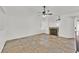 Living room featuring tile floors, a ceiling fan, and a cozy fireplace at 3514 Jordan Ln, North Las Vegas, NV 89032