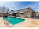 Sparkling backyard pool with ladder surrounded by concrete patio at 3696 Monte Verde St, Las Vegas, NV 89121