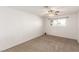 Empty bedroom featuring neutral carpet, a ceiling fan, and a bright window at 3696 Monte Verde St, Las Vegas, NV 89121