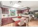 Bright kitchen features dark cabinetry, a skylight, and a center island with seating at 3696 Monte Verde St, Las Vegas, NV 89121