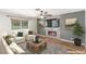 Cozy living room features a modern electric fireplace, ceiling fan, and large window at 3696 Monte Verde St, Las Vegas, NV 89121