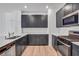 Modern kitchen featuring stainless steel appliances and dark cabinetry at 3757 Via Gennaro, Henderson, NV 89044