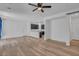 Open-concept living space with hardwood floors, view of kitchen and modern ceiling fan at 3757 Via Gennaro, Henderson, NV 89044