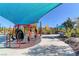 Community playground area with shade structure, equipment, and walking paths at 3757 Via Gennaro, Henderson, NV 89044