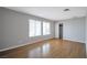 Spacious bedroom featuring hardwood floors, large windows, and a sliding door closet at 3966 Torsby Pl, Las Vegas, NV 89119