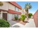 Charming two-story townhouse featuring a red tile roof, stone accents, and lush landscaping at 3966 Torsby Pl, Las Vegas, NV 89119