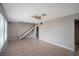 Open-concept living room featuring tile flooring, staircase and plenty of natural light at 3966 Torsby Pl, Las Vegas, NV 89119