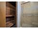 Modern shower with a seamless glass door, beautiful tile, and a traditional wooden sauna at 3966 Torsby Pl, Las Vegas, NV 89119