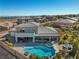 Aerial view of home featuring private pool, hot tub, outdoor kitchen, patio area, and second story balcony at 4081 Turquoise Falls St, Las Vegas, NV 89129