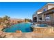 Resort-style backyard with a custom pool, spa, and outdoor kitchen at 4081 Turquoise Falls St, Las Vegas, NV 89129