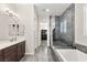 Modern bathroom with a glass-enclosed shower, soaking tub, and stylish fixtures at 4081 Turquoise Falls St, Las Vegas, NV 89129