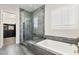 Elegant bathroom featuring a glass shower, soaking tub, and access to a large walk-in closet at 4081 Turquoise Falls St, Las Vegas, NV 89129