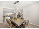 Bright dining room with modern chandelier, view to the back yard, and view to the staircase at 4081 Turquoise Falls St, Las Vegas, NV 89129