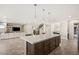 Open-concept kitchen with eat-in center island and an open view into the living room and staircase at 4081 Turquoise Falls St, Las Vegas, NV 89129