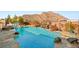 Beautiful backyard pool featuring a waterfall and slide, ideal for Gathering fun and relaxation at 4081 Turquoise Falls St, Las Vegas, NV 89129