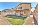 Wide backyard view features a covered patio, green lawn, and well-kept landscaping at 4116 Free Bird Crest Ave, North Las Vegas, NV 89081