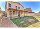 Expansive backyard with a covered patio, lush lawn, and low-maintenance landscaping at 4116 Free Bird Crest Ave, North Las Vegas, NV 89081