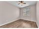 Clean bedroom with wood-look flooring, neutral walls, and a window with blinds at 4116 Free Bird Crest Ave, North Las Vegas, NV 89081