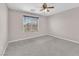 Neutral bedroom with ample sunlight, carpet, and a ceiling fan at 4116 Free Bird Crest Ave, North Las Vegas, NV 89081