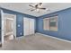 Blue painted bedroom featuring carpet, ceiling fan, closet, and a window at 4116 Free Bird Crest Ave, North Las Vegas, NV 89081