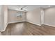 Bedroom featuring hardwood floors, a ceiling fan, and a large window providing ample natural light and comfort at 4116 Free Bird Crest Ave, North Las Vegas, NV 89081