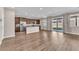 Open kitchen layout with wood cabinets, stainless steel appliances and wood-look flooring at 4116 Free Bird Crest Ave, North Las Vegas, NV 89081