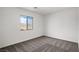 Cozy bedroom with neutral carpet, white walls, and natural light from the window at 4211 Gold Desert St, North Las Vegas, NV 89032