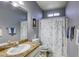 Cozy bathroom featuring granite countertops, ample cabinet space, and a decorative shower curtain at 4260 E Cincinnati Ave, Las Vegas, NV 89104