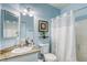 Bathroom vanity and framed mirror above a toilet and shower at 4260 E Cincinnati Ave, Las Vegas, NV 89104