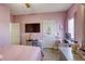 Pink bedroom featuring a bed, a desk and chair, with decor at 4260 E Cincinnati Ave, Las Vegas, NV 89104