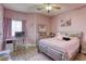 Cozy pink bedroom featuring a desk with computer, a bed, and pink decor at 4260 E Cincinnati Ave, Las Vegas, NV 89104