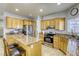 Bright kitchen with wooden cabinets, granite countertops, and stainless steel appliances at 4260 E Cincinnati Ave, Las Vegas, NV 89104