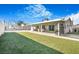 An outdoor patio opens onto a backyard with artificial grass, offering a low-maintenance space for outdoor activities at 4303 E Viking Rd, Las Vegas, NV 89121