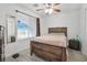 A bright bedroom boasts natural light, a comfortable bed, and a ceiling fan for a relaxing and restful atmosphere at 4303 E Viking Rd, Las Vegas, NV 89121