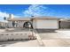 Inviting single-story home with a two-car garage, paved driveway, and secure gated entrance for added privacy at 4303 E Viking Rd, Las Vegas, NV 89121