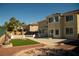 Expansive backyard featuring a patio, synthetic grass, and well-maintained landscaping providing an ideal space for outdoor activities at 4384 Grey Spencer Dr, Las Vegas, NV 89141