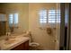 Bathroom featuring a wide mirror, sink, and a window with plantation shutters, offering a bright and functional space at 4384 Grey Spencer Dr, Las Vegas, NV 89141