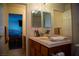 Bathroom with wood cabinets, double mirror, sink and vanity with the Primary bedroom in view at 4384 Grey Spencer Dr, Las Vegas, NV 89141