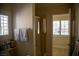 Bright bathroom featuring a glass shower and window with plantation shutters at 4384 Grey Spencer Dr, Las Vegas, NV 89141