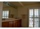 Bathroom sink and mirror with shuttered windows providing natural light at 4384 Grey Spencer Dr, Las Vegas, NV 89141