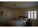 Comfortable bedroom features a queen bed, neutral colors, and bright window with plantation shutters at 4384 Grey Spencer Dr, Las Vegas, NV 89141