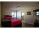 Cozy bedroom features a queen bed with pink bedding, neutral colors, and bright window with shutters at 4384 Grey Spencer Dr, Las Vegas, NV 89141