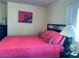 Bedroom featuring bright pink bedding, dark furniture, and natural lighting from window at 4384 Grey Spencer Dr, Las Vegas, NV 89141